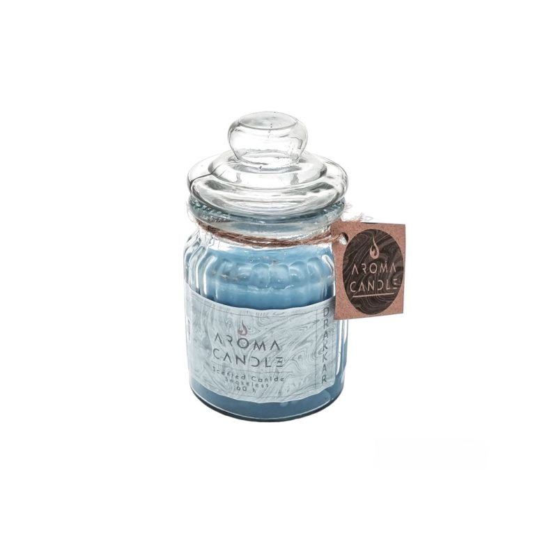 A sky-blue scented jar candle in a glass jar with a lid and a label attached reading Aroma Candle. Image relates to a product titled: شمع معطر لیوانی دراکار نوآر (Drakkar Noir)